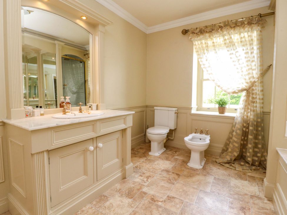 A bathroom with a sink, toilet, and bidet at Laithe House in Burnley
