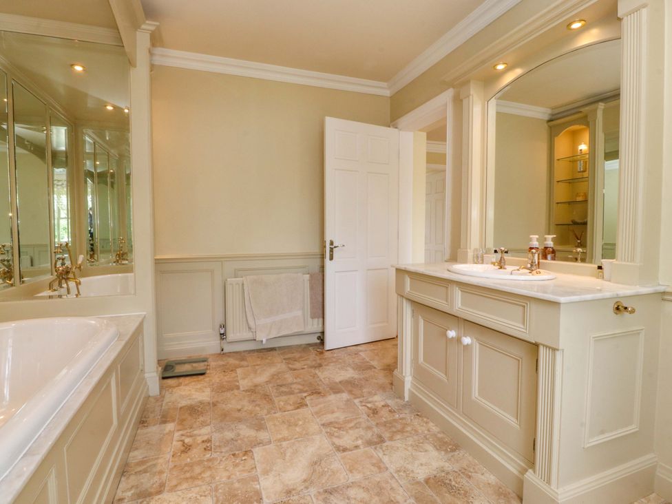 A bathroom with a bathtub and sink at Laithe House in Burnley