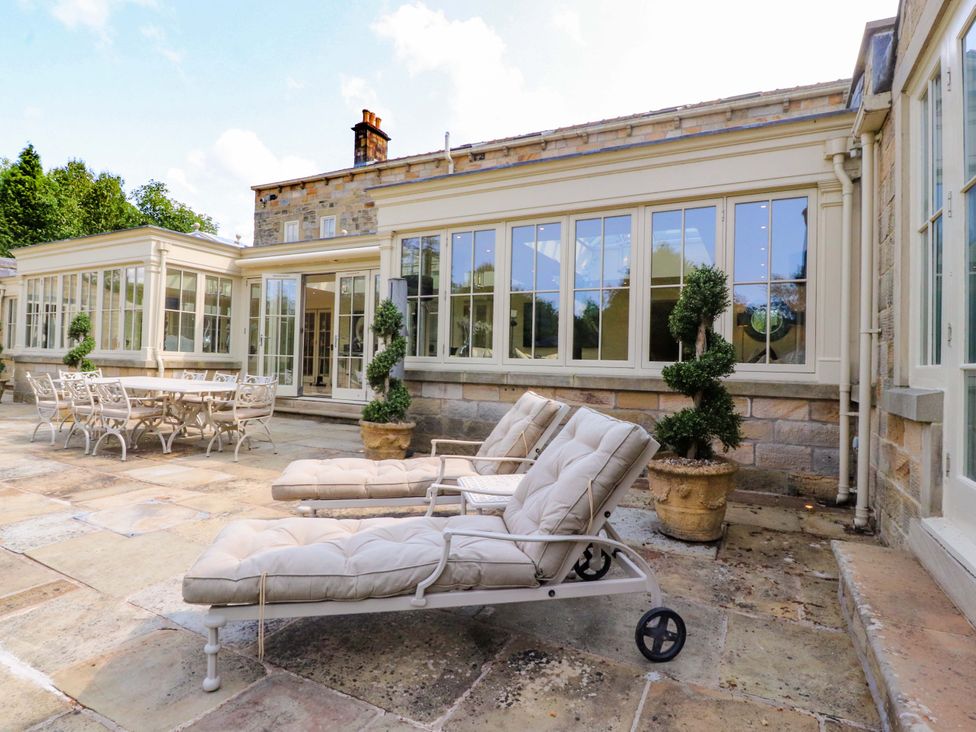 An outdoor area with seating and a table at Laithe House in Burnley