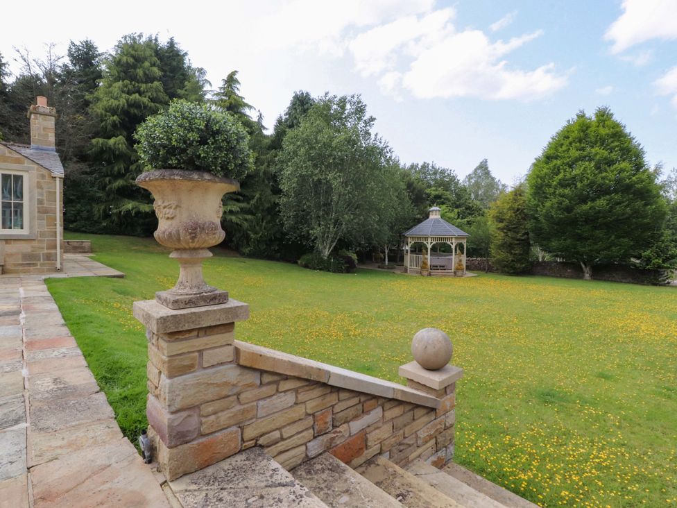 A garden with a gazebo and urn at Laithe House in Burnley