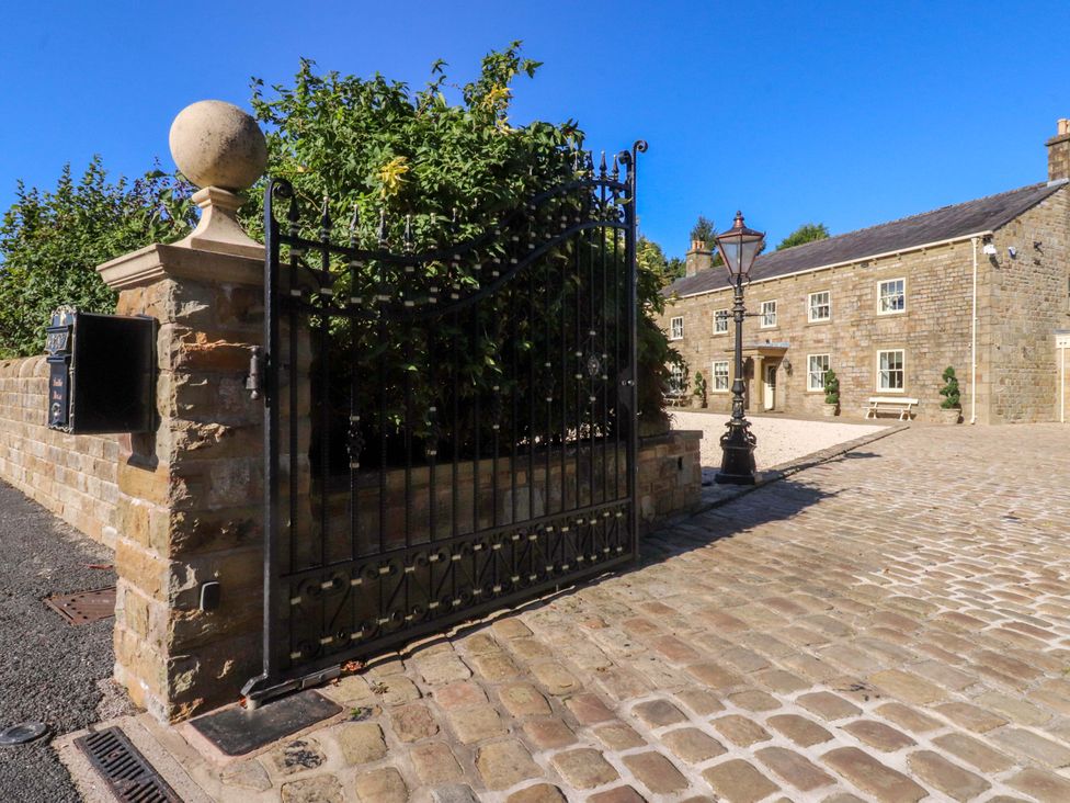 A property entrance with a gate and mailbox at Laithe House in Cliviger