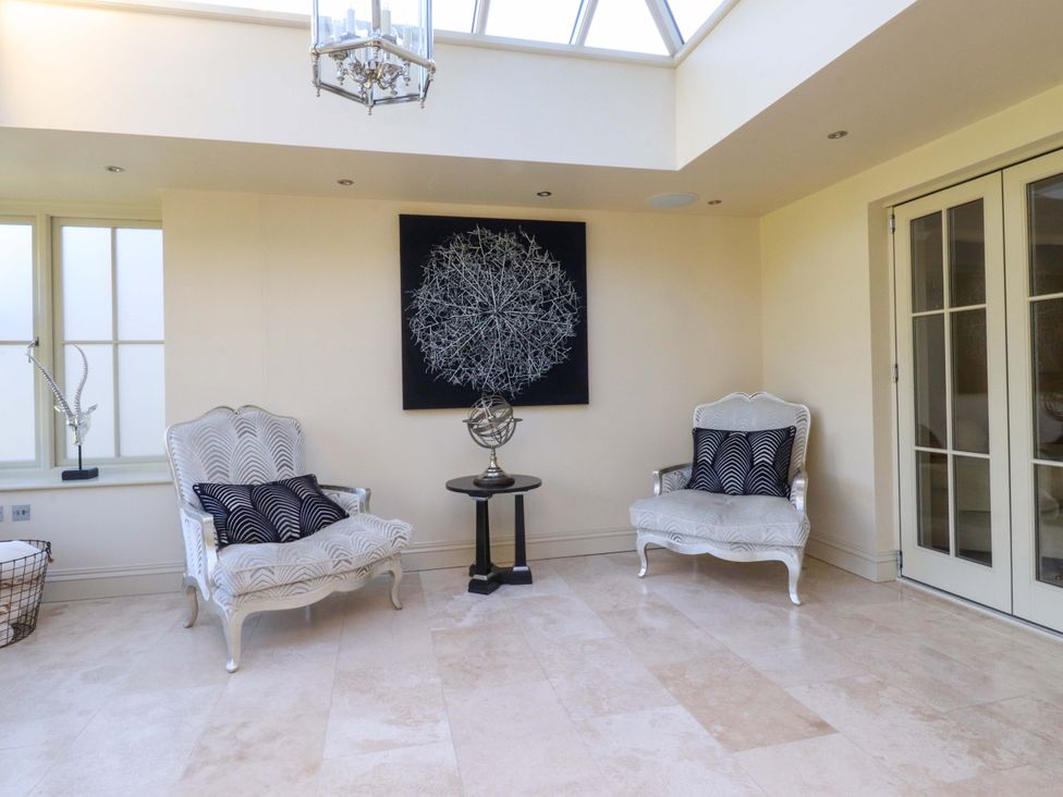 A snug area with two chairs and a coffee table at Laithe House in Cliviger