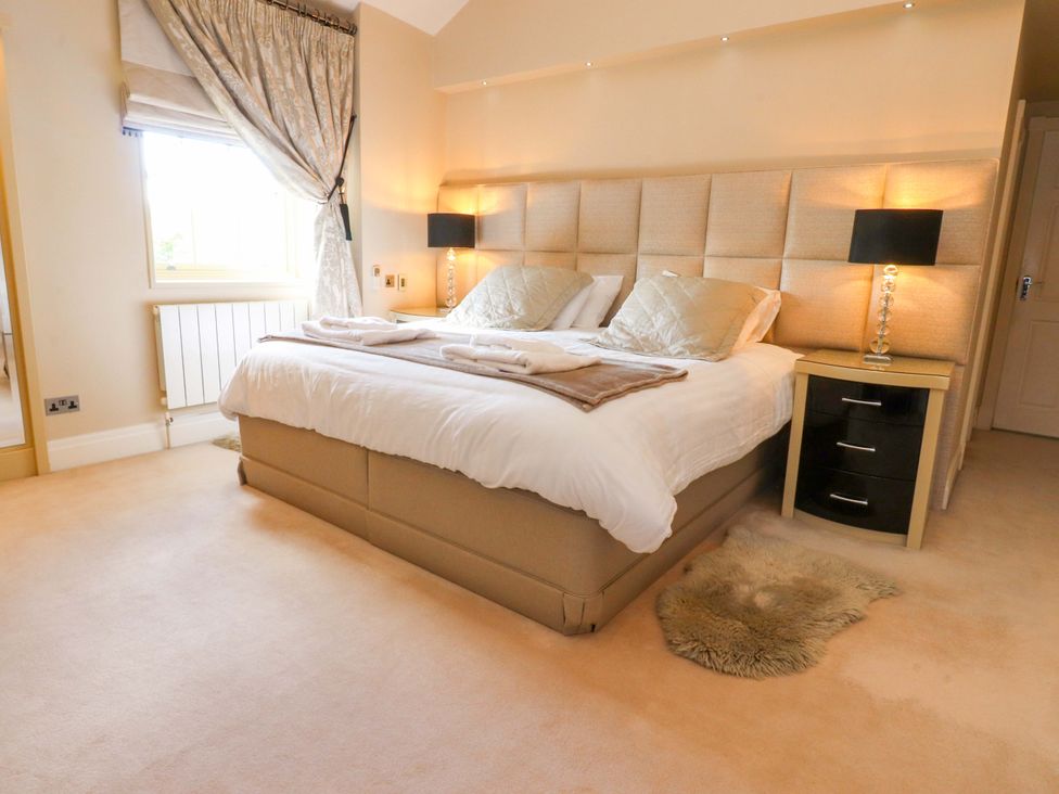 A bedroom with a bed and nightstand at Laithe House in Cliviger