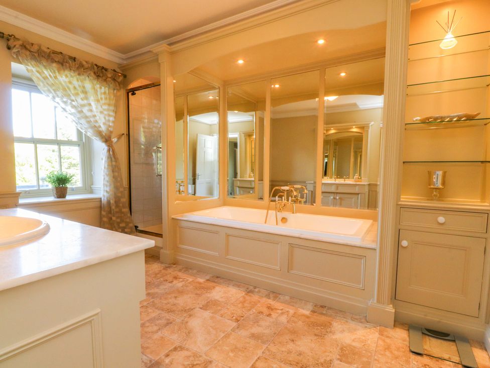 A bathroom with a bathtub and shower at Laithe House in Cliviger