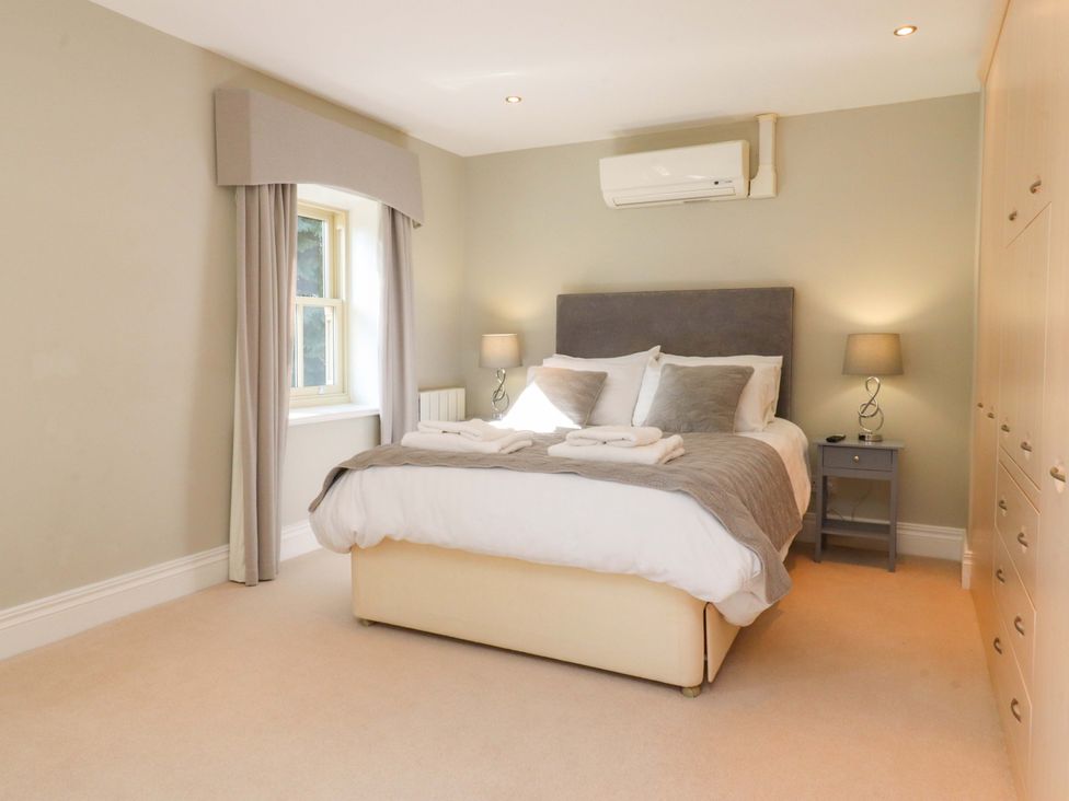 A bedroom with a bed and bedside table at Laithe House in Cliviger