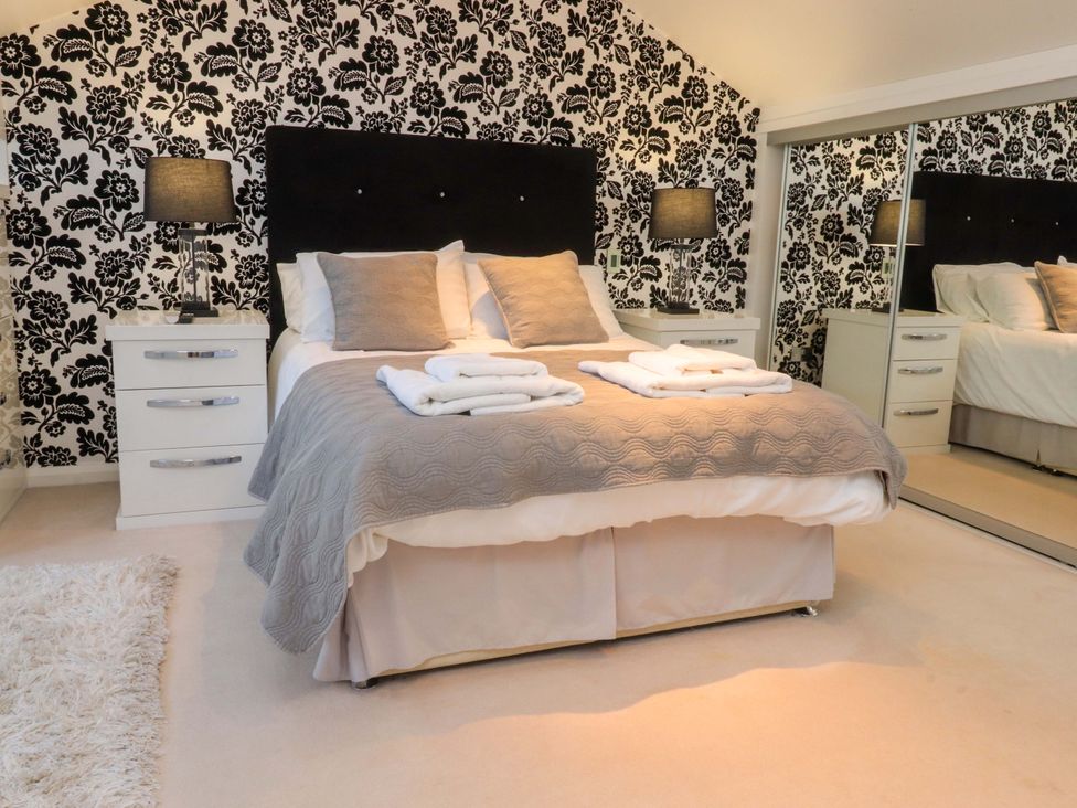 A bedroom with a bed and nightstand at Laithe House in Cliviger