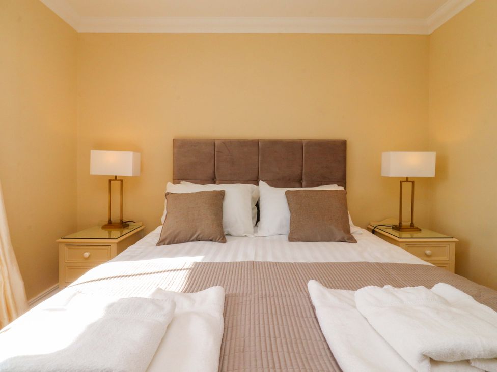 A bedroom with a bed and bedside tables at Laithe House in Cliviger