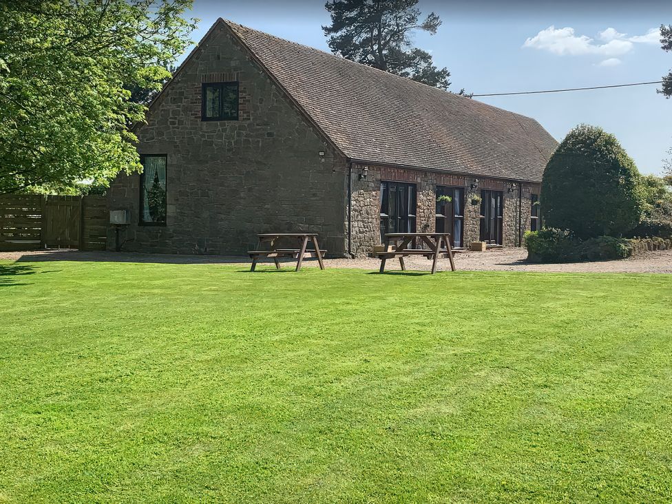 A house with lawn and outdoor seating at Upper Home Farm