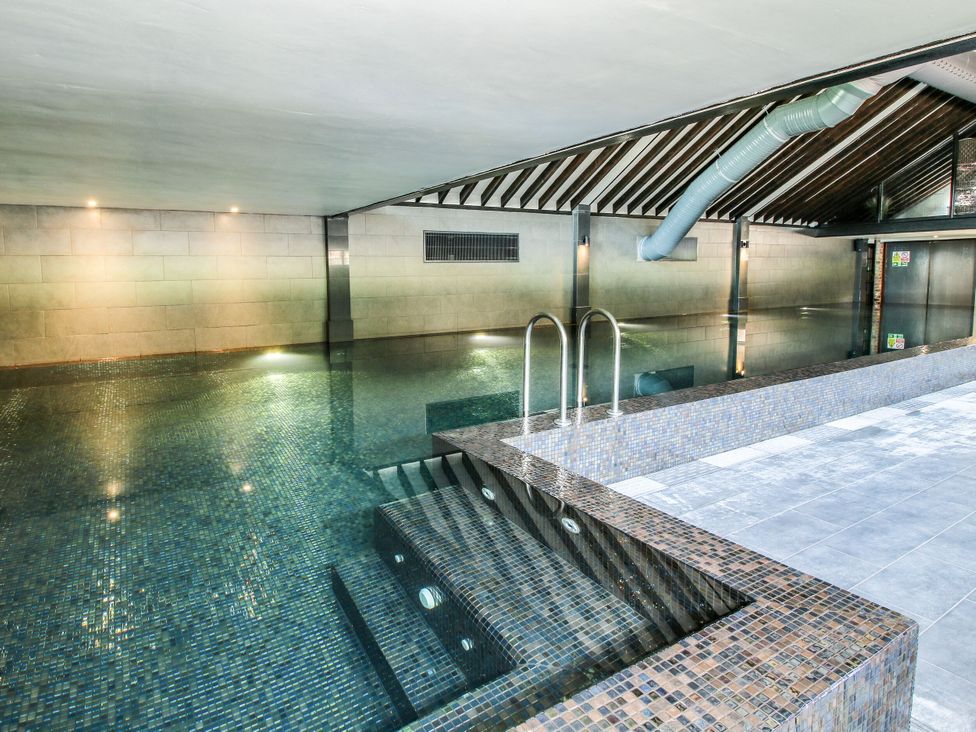 An indoor pool area with tiles and steps at Upper Home Farm near Cardington
