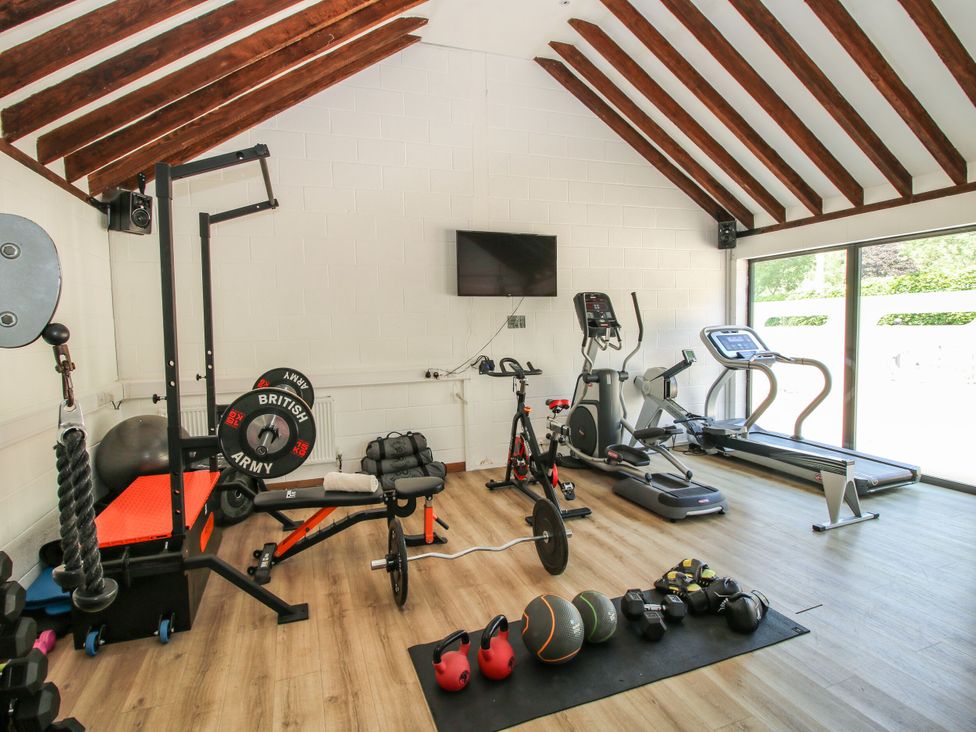 A gym with various exercise equipment at Upper Home Farm near Cardington