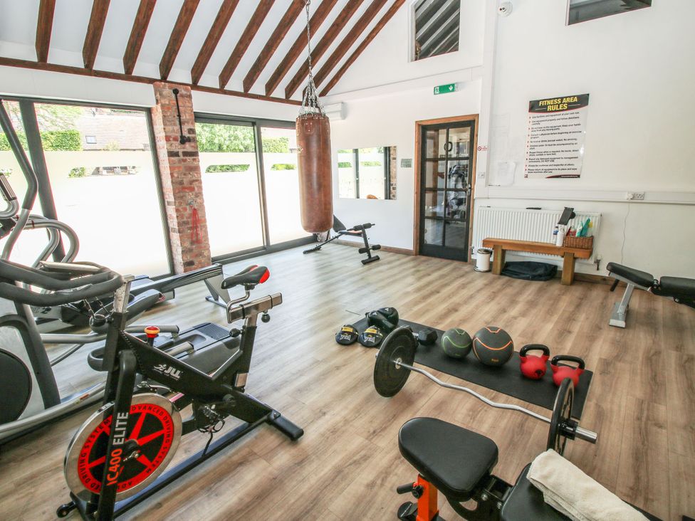 A gym with exercise equipment at Upper Home Farm near Cardington