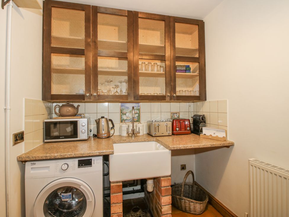 A kitchen with a sink and appliances at Upper Home Farm near Cardington