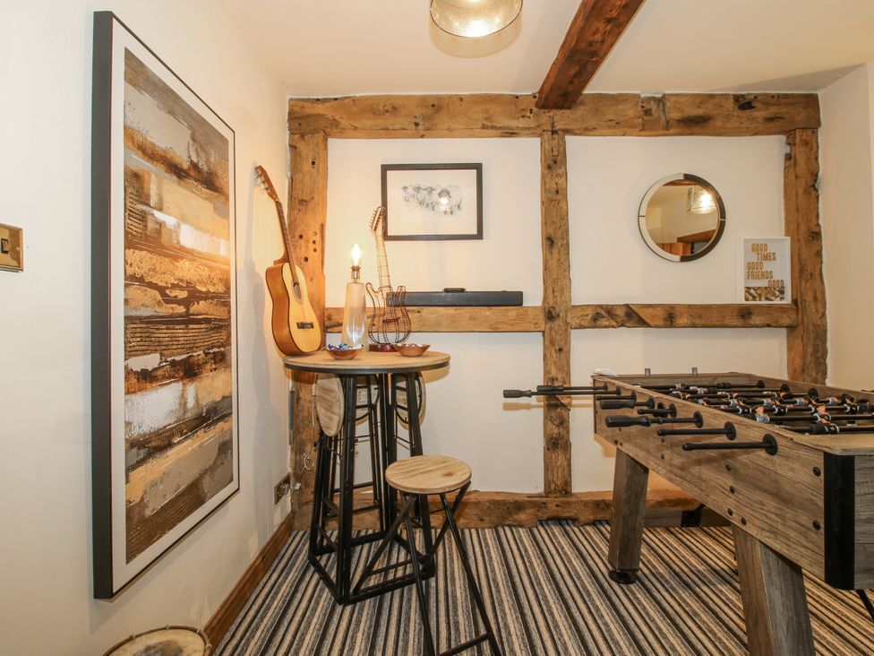 A game room with a foosball table and a stool at Upper Home Farm near Cardington