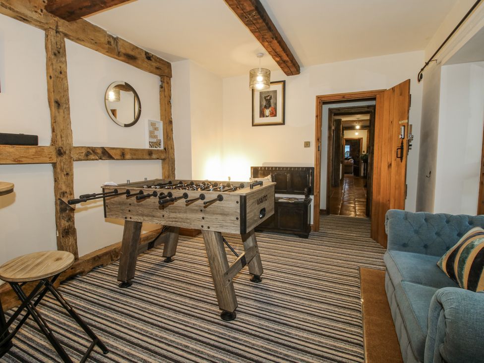 A game room with a foosball table and sofa at Upper Home Farm near Cardington