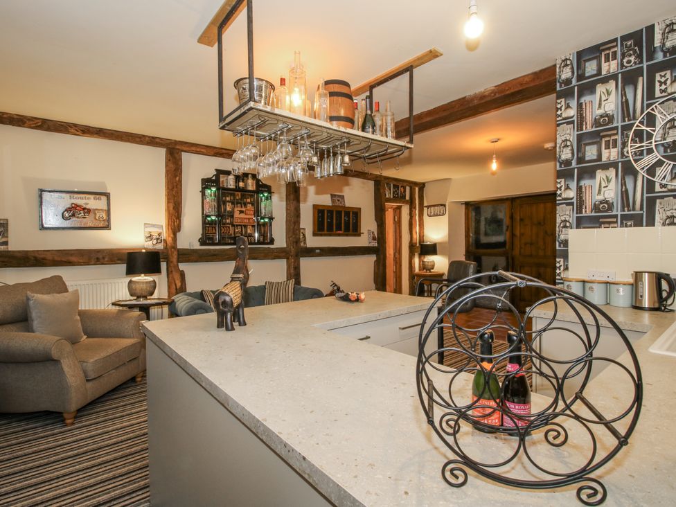 A kitchen with an island and a sitting area at Upper Home Farm near Cardington
