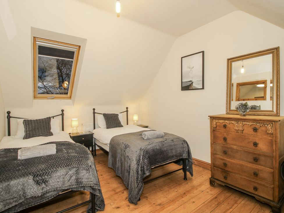 A bedroom with two beds and a dresser at Upper Home Farm near Cardington