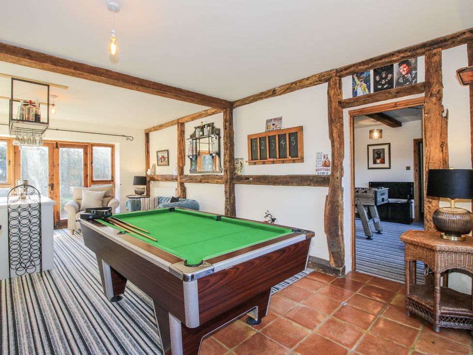 A snug with a pool table and seating area at Upper Home Farm near Cardington
