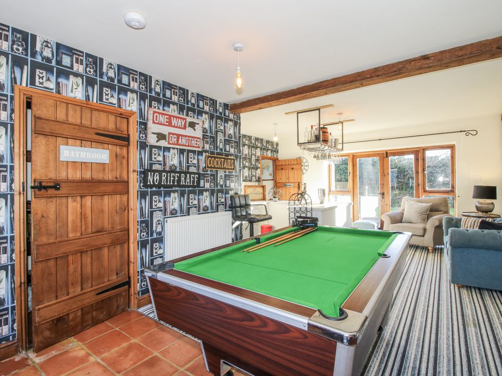 A snug with a pool table and seating at Upper Home Farm near Cardington
