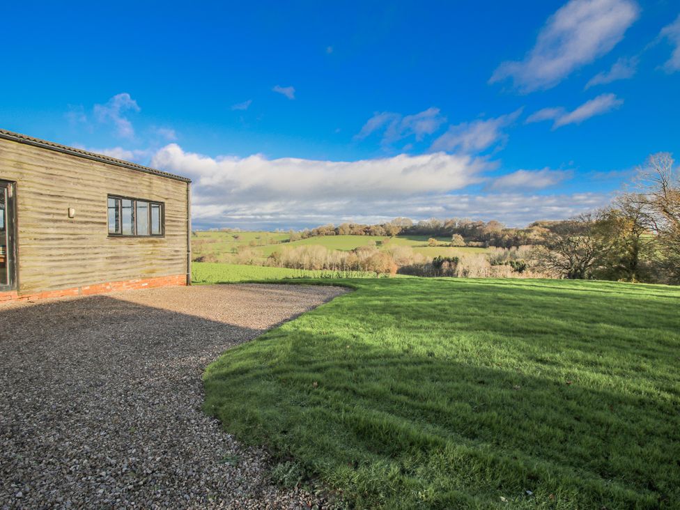 A house with a gravel area and grass at Upper Home Farm near Cardington