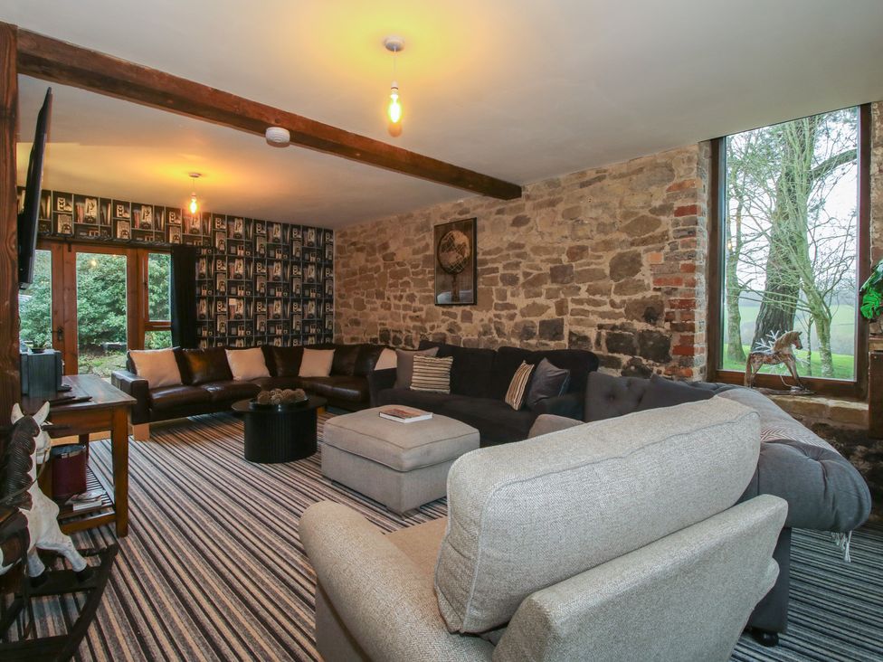 A living room with a sofa and coffee table at Upper Home Farm near Cardington