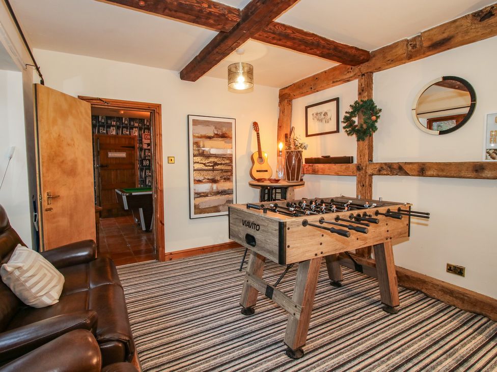 A snug with a foosball table and guitar at Upper Home Farm near Cardington