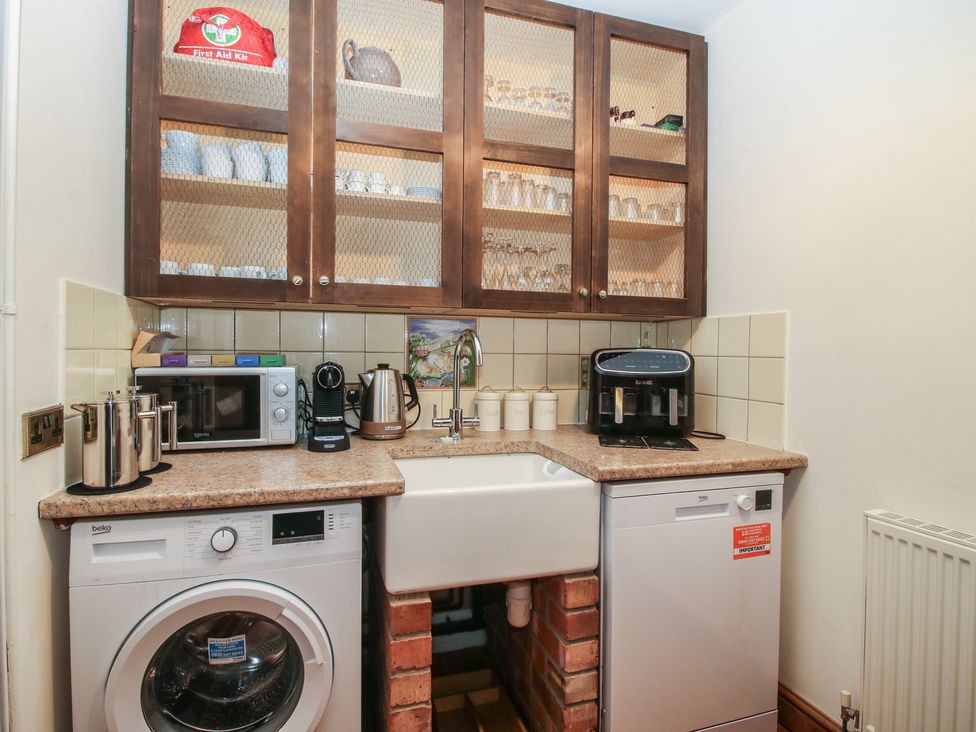 A utility room with appliances and storage at Upper Home Farm near Cardington