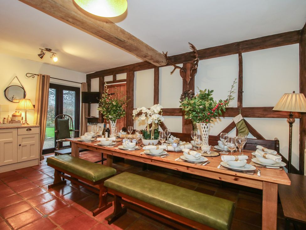 A dining room with a table set for a meal at Upper Home Farm near Cardington