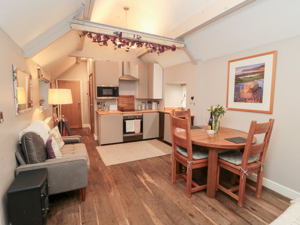 A kitchen area with dining table and seating at Maltkiln House Annexe Chop Gate near Stokesley