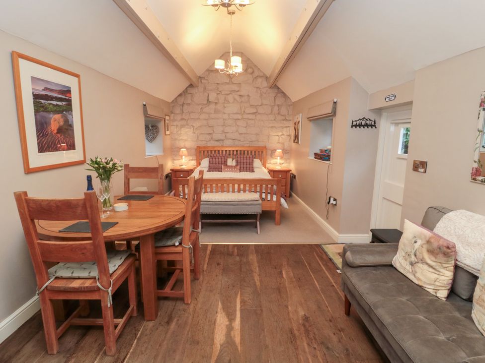 A living room with a bed and dining table at Maltkiln House Annexe Chop Gate near Stokesley