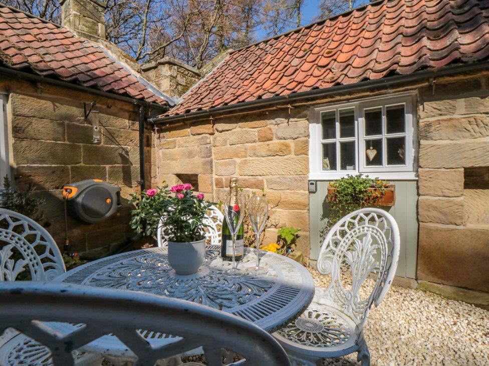 An outdoor seating area with a table and chairs at Maltkiln House Annexe in Chop Gate near Stokesley