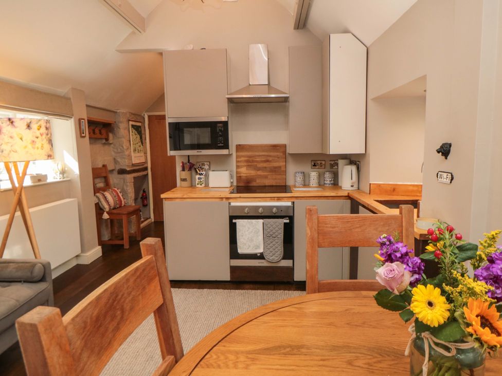 A kitchen with appliances and dining area at Maltkiln House Annexe Chop Gate near Stokesley