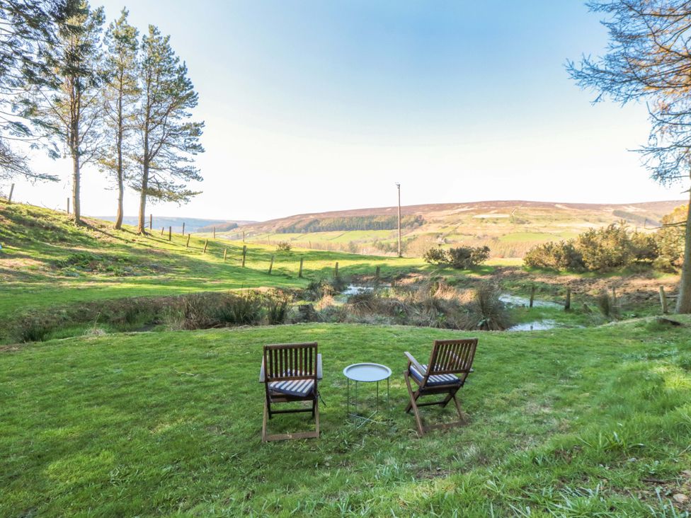 Two chairs and a table in a garden at Maltkiln House Annexe Chop Gate near Stokesley