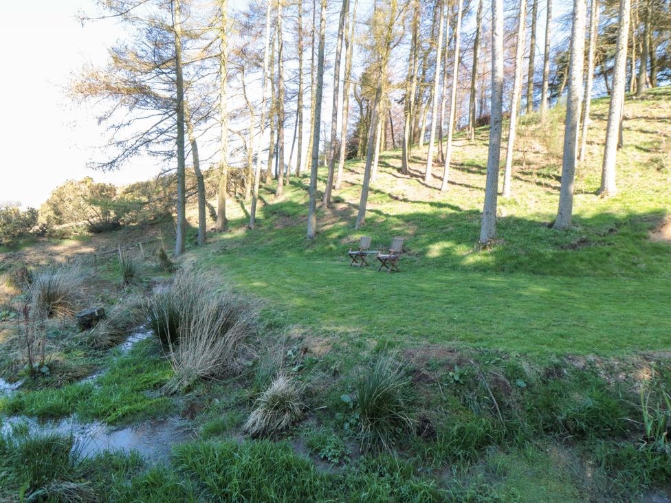 A grassy area with chairs and trees at Maltkiln House Annexe Chop Gate near Stokesley