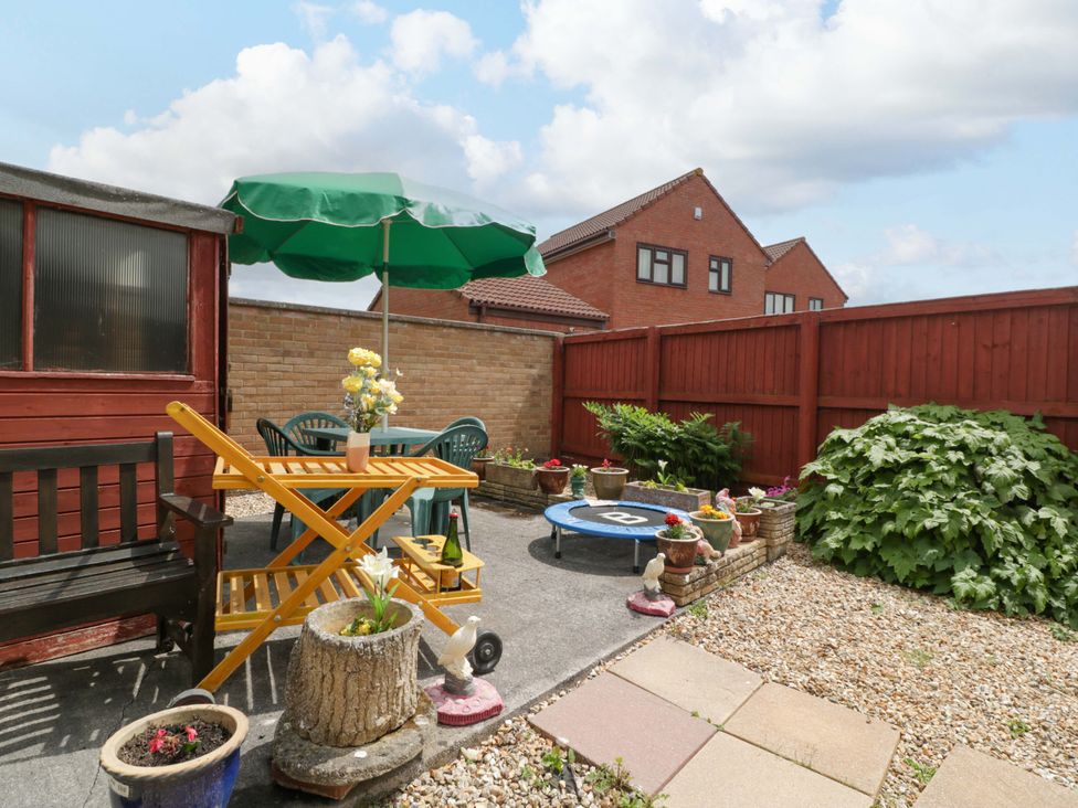 A garden with seating and plants at Fatima in Burnham-On-Sea