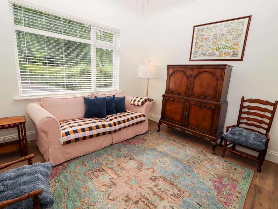 A living room with a sofa and a cabinet at Rosemont in Adare
