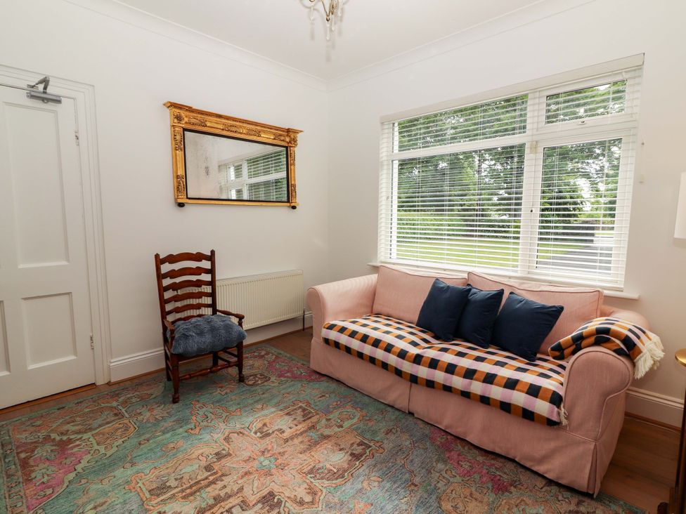 A living room with a sofa and a chair at Rosemont in Adare