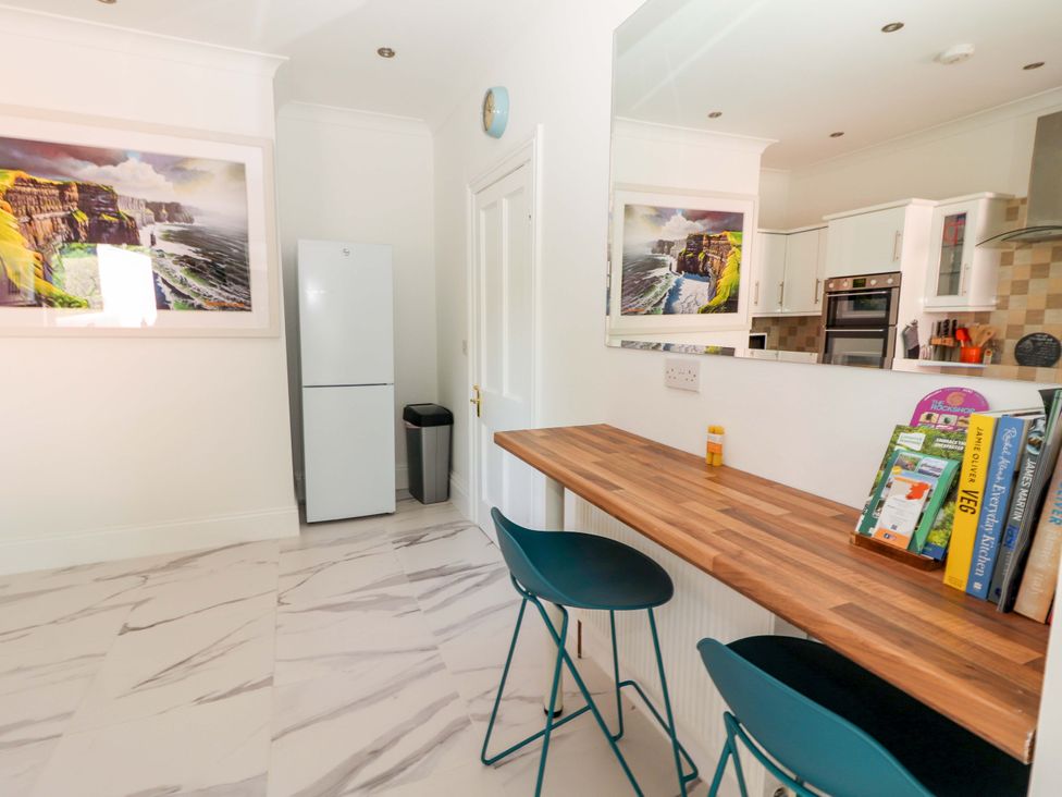 A kitchen with bar seating and appliances at Rosemont in Adare