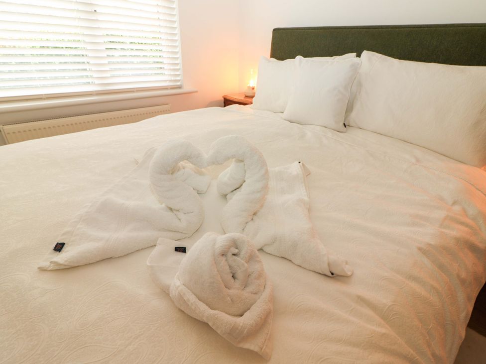 A bedroom with towels arranged in shape of swans at Rosemont in Adare