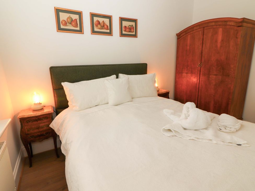 A bedroom with a bed and nightstand at Rosemont in Adare