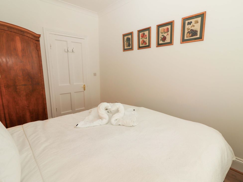 A bedroom with a bed and wardrobe at Rosemont in Adare