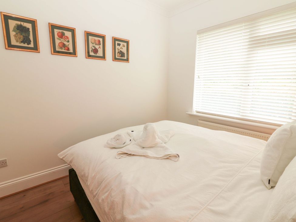 A bedroom with a bed and wall art at Rosemont in Adare