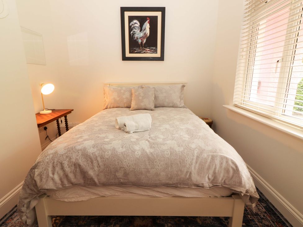 A bedroom with a bed and wall art at Rosemont in Adare