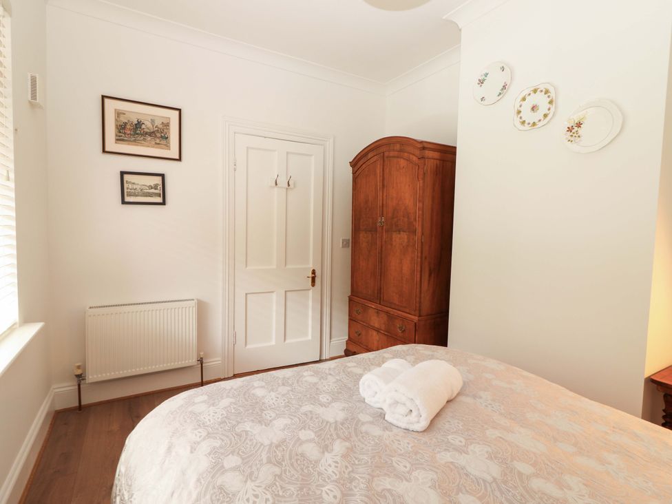 A bedroom with a bed and wardrobe at Rosemont in Adare