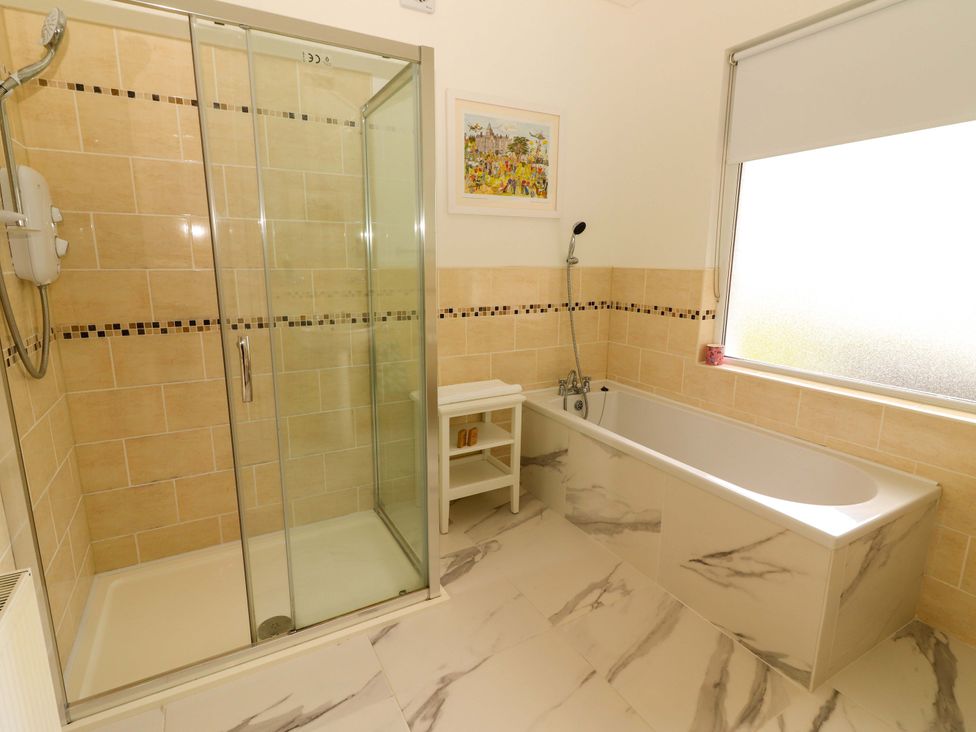 A bathroom with a shower and a bathtub at Rosemont in Adare