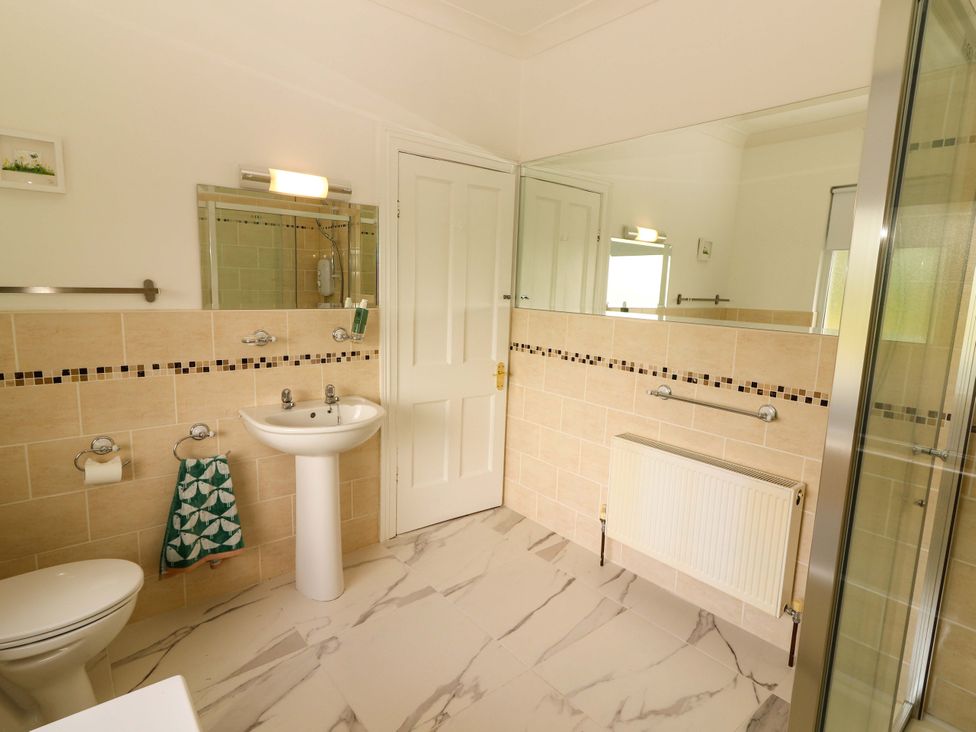 A bathroom with a sink, toilet, and shower at Rosemont in Adare