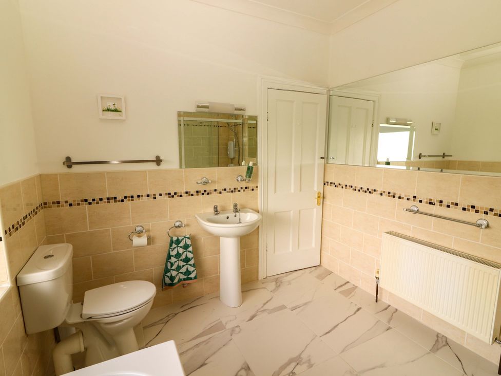 A bathroom with a toilet and wash basin at Rosemont in Adare