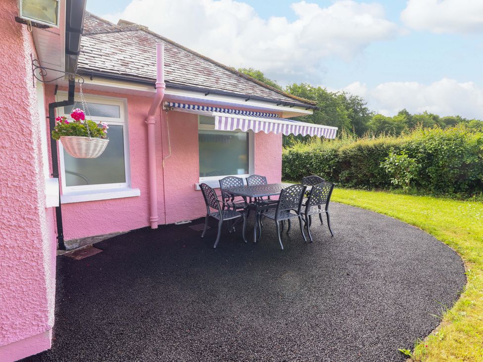 An outdoor seating area with a table and chairs at Rosemont in Adare