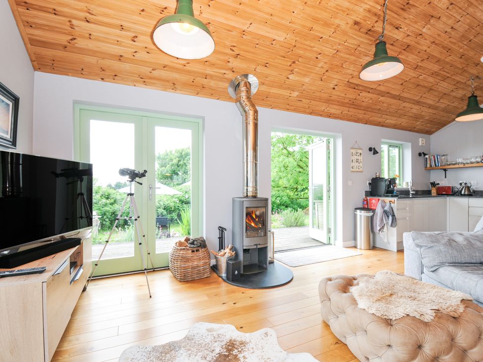 A living room with a stove and television at Smugglers Bodmin Moor, St Breward near St Tudy