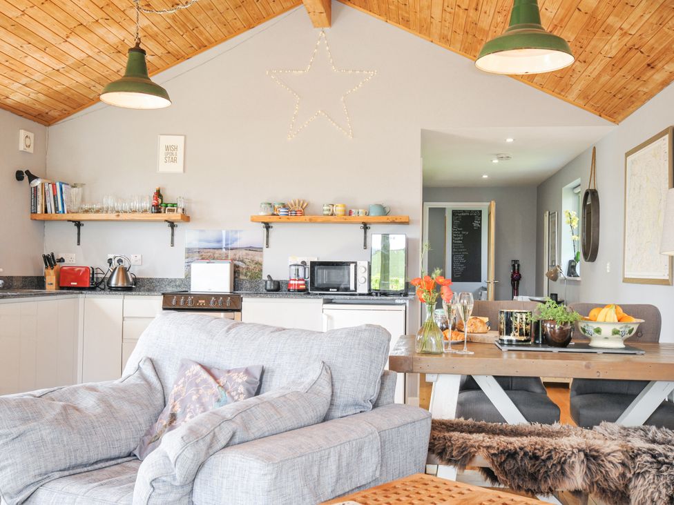 A kitchen with a sofa and dining table at Smugglers Bodmin Moor, St Breward near St Tudy