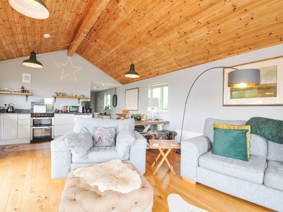 A living room with a couch and a dining area at Smugglers Bodmin Moor, St Breward near St Tudy